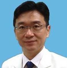 an image of Hsu wearing a white shirt, black tie and smiling 