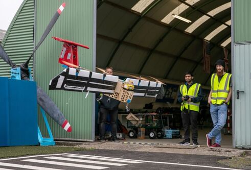 2 people on an airport hanger with the aerospace device 