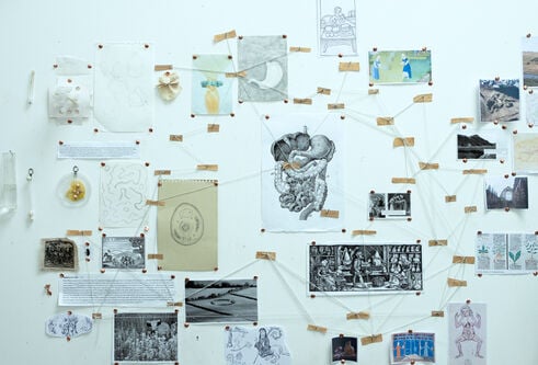 Selection of artwork and images on a wall