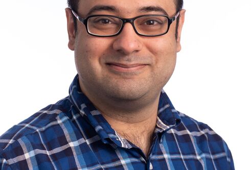 man in glasses wearing blue checked shirt