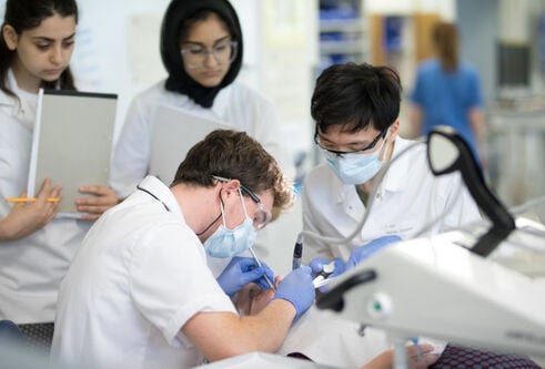 Dentistry students wearing protective masks and glasses performing clinical skills at Dundee.