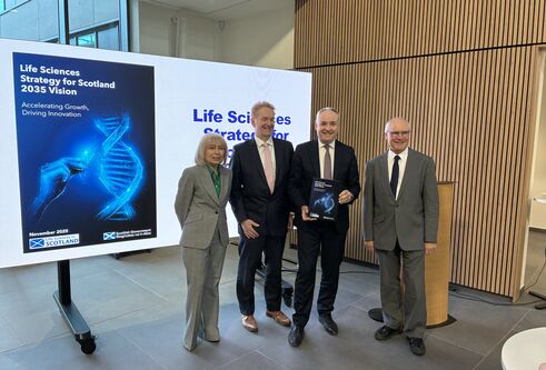 Representatives of the University and Scottish Government with the launch document