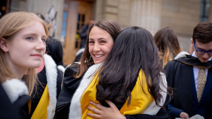 graduating students hugging