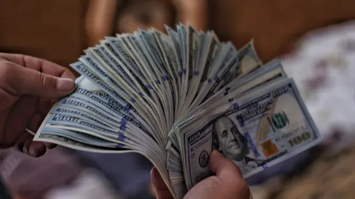 cash notes being held in a hand