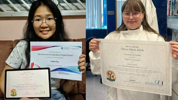 Two people smiling holding certificates