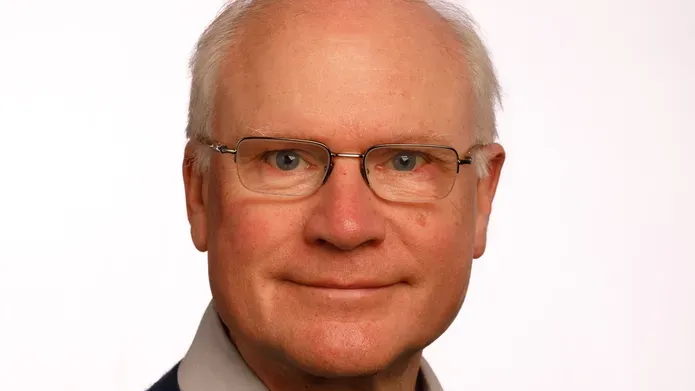 Prof Sir Mike Ferguson looking straight at the camera against a white background