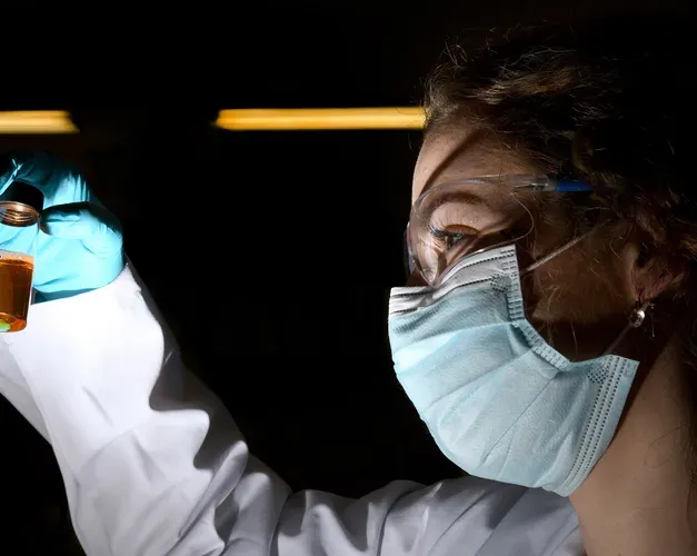 Scientist looking at bottle
