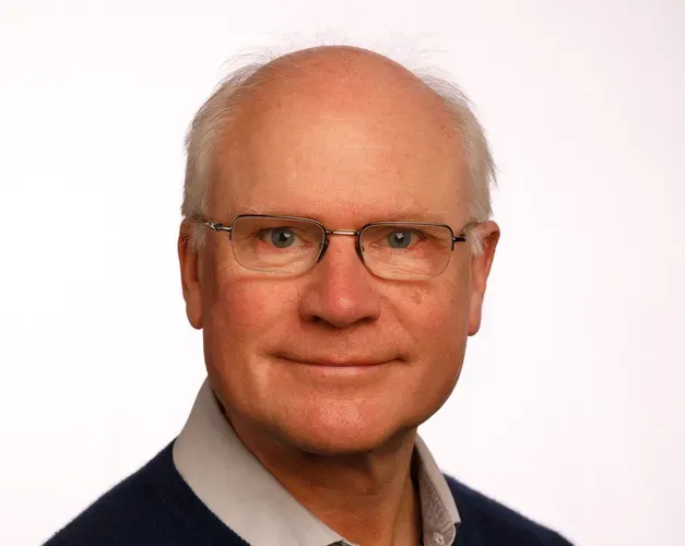 Prof Sir Mike Ferguson looking straight at the camera against a white background