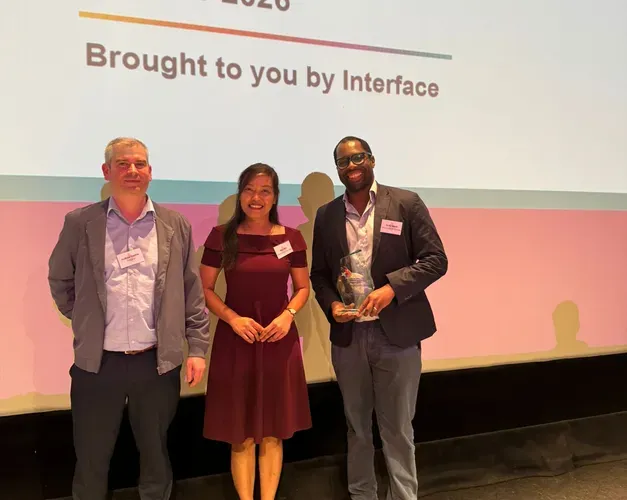 Dr Ify Mordi and colleagues with their award on stage