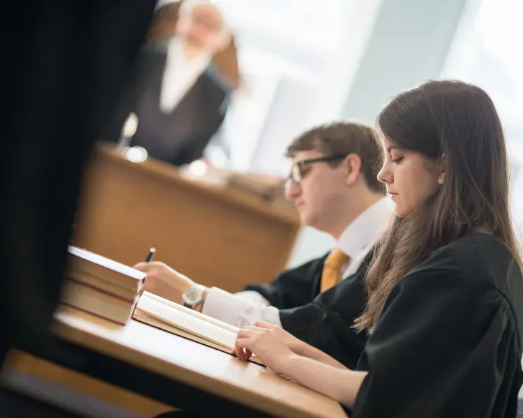 Law students looking at documents in the mooting room