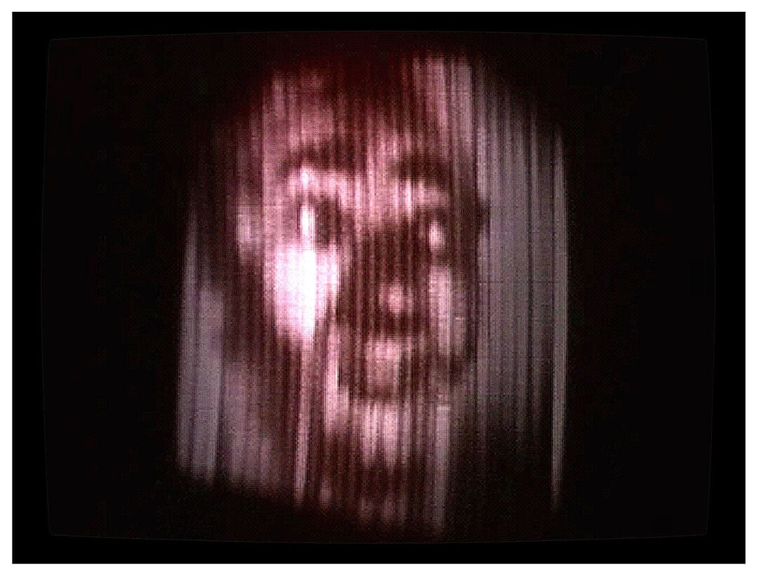 head on a screen with lines down it