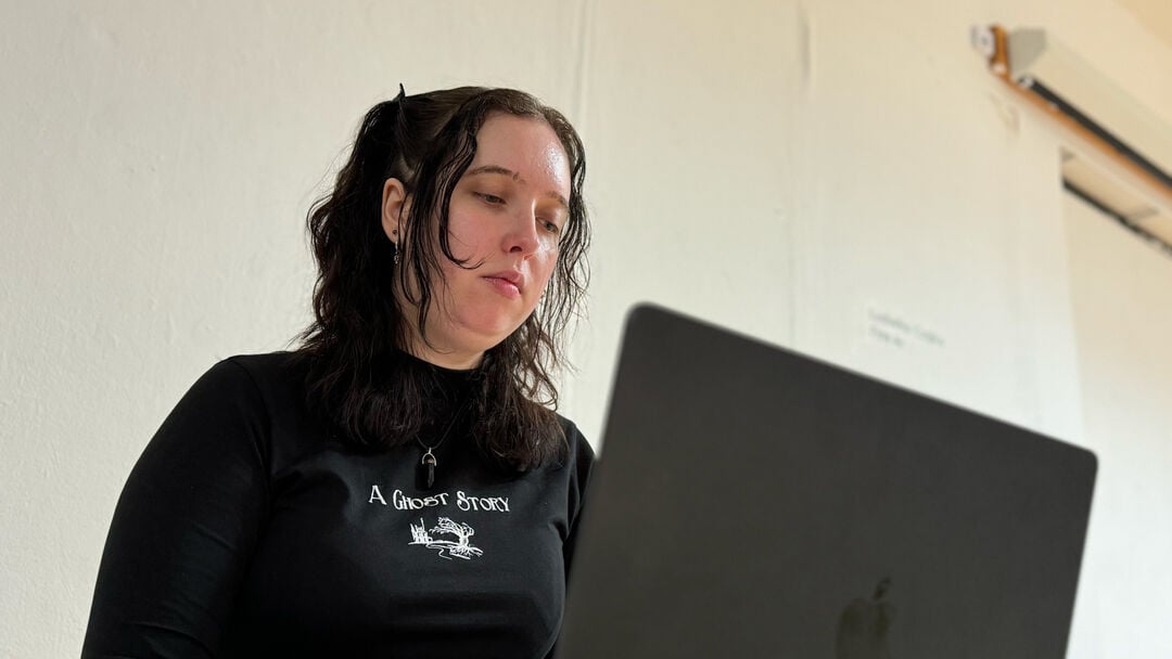 Leah working on a laptop