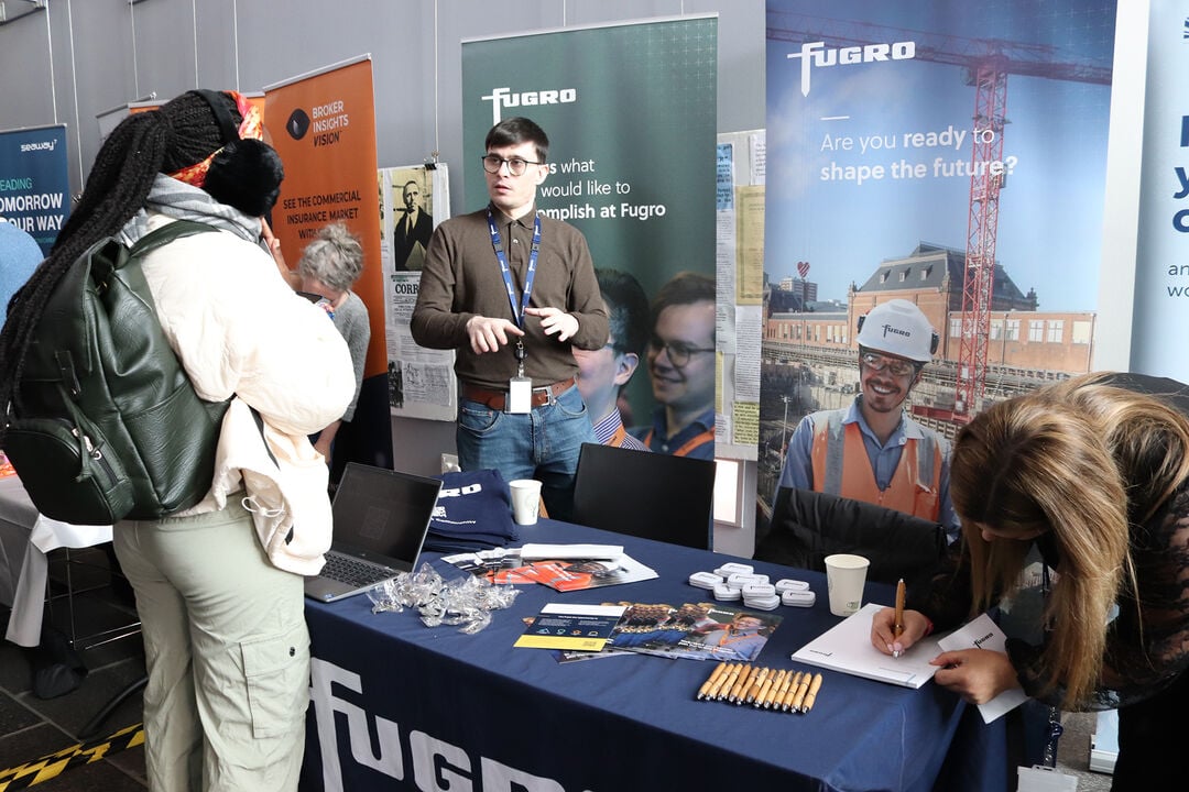 A student in front of a Fugros stand at the SSEN Careers Expo