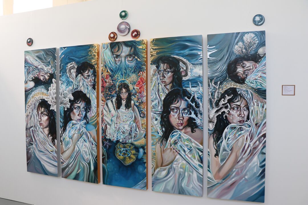 series of five long, thin, rectangle shaped paintings, which stand upright and are all different but connected. Each features a woman, pearls and a sea theme 