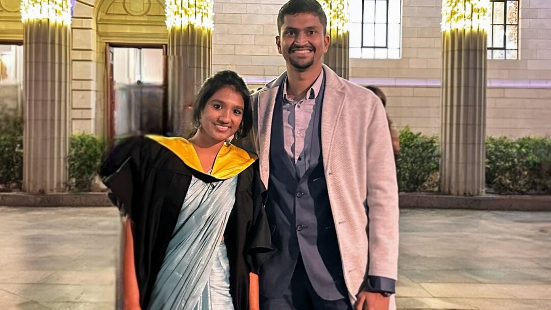Pavithra in her graduation gown outside Caird Hall